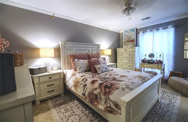 carpeted bedroom with crown molding and ceiling fan