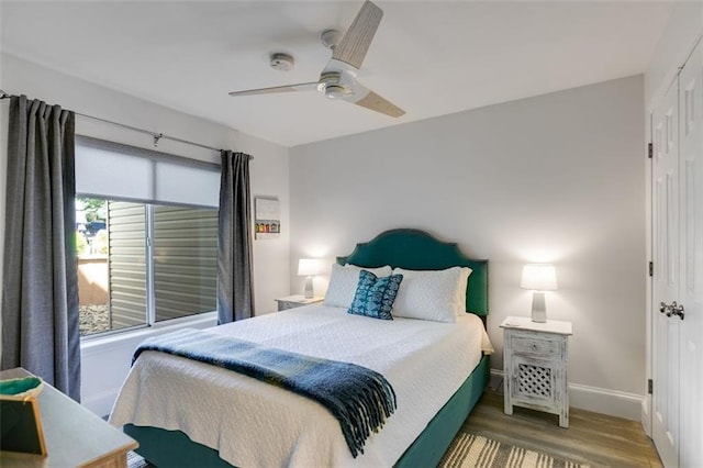 705 Berry Ct, Villa Rica, GA 30180 - bedroom featuring baseboards, wood finished floors, ceiling fan, and a closet