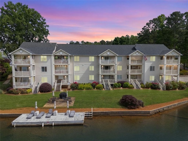 705 Berry Ct, Villa Rica, GA 30180 - property at dusk featuring a water view and stairs