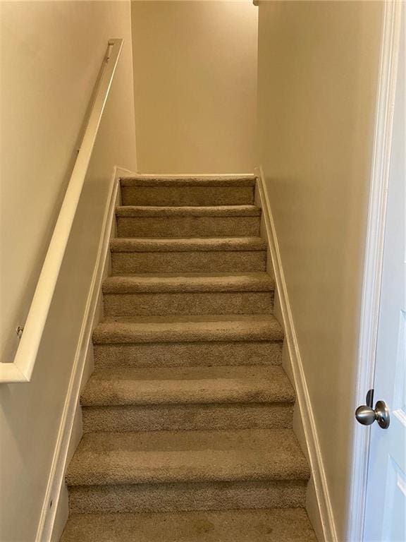 stairs with carpet flooring and baseboards