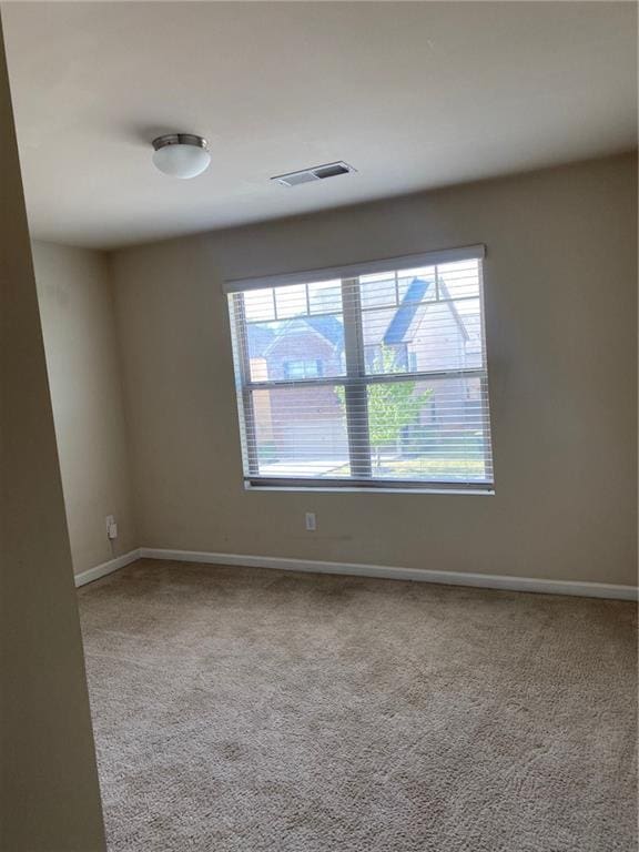 empty room with carpet flooring and baseboards