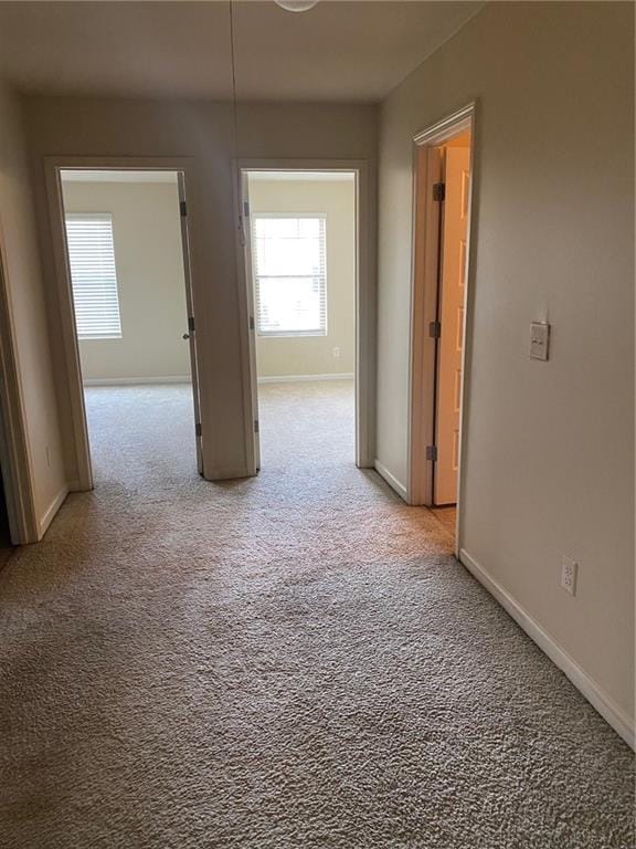 carpeted spare room with baseboards