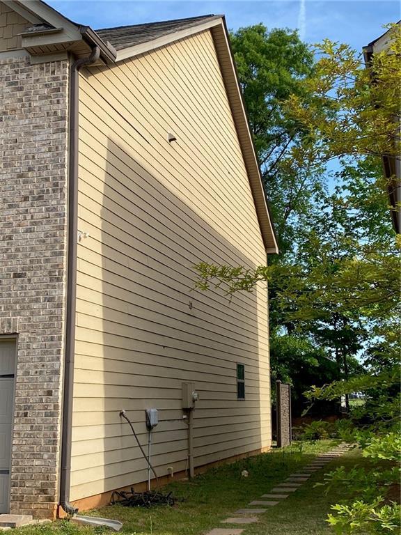 view of side of property featuring brick siding