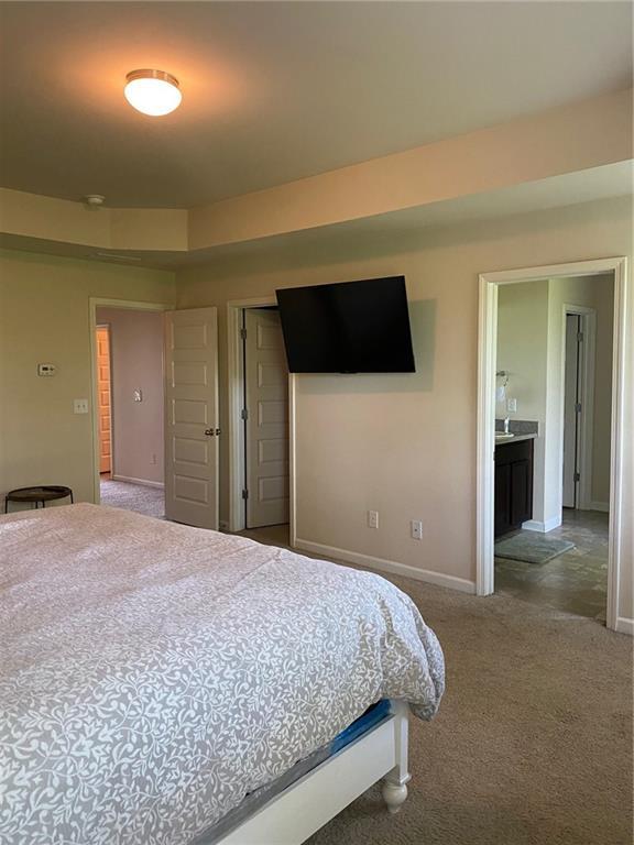 carpeted bedroom with baseboards and a closet