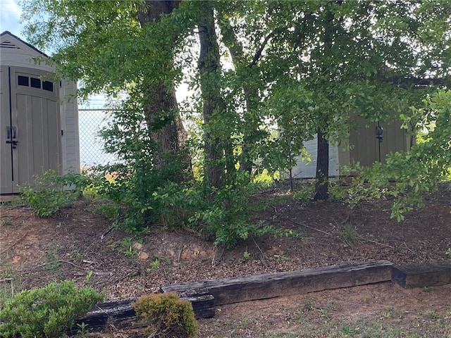 view of yard with a shed and an outbuilding