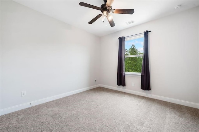 unfurnished room with light carpet, baseboards, and ceiling fan