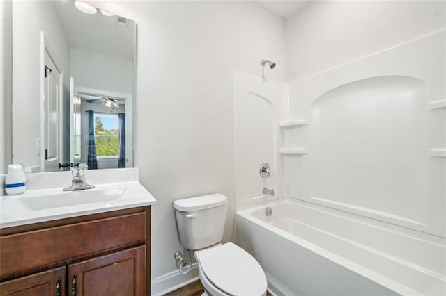 full bath with vanity, toilet, bathing tub / shower combination, and baseboards