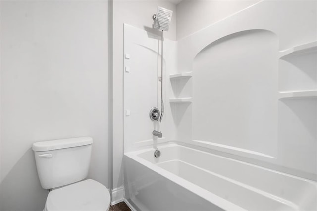 bathroom with toilet, shower / tub combination, and baseboards