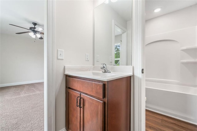 bathroom with vanity, ceiling fan, washtub / shower combination, baseboards, and recessed lighting