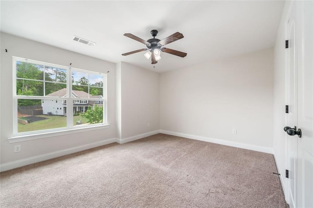 empty room featuring carpet flooring, baseboards, and ceiling fan