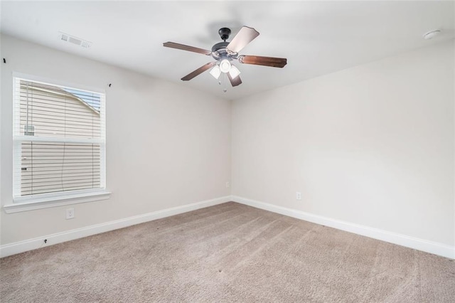 spare room with baseboards, carpet floors, and ceiling fan
