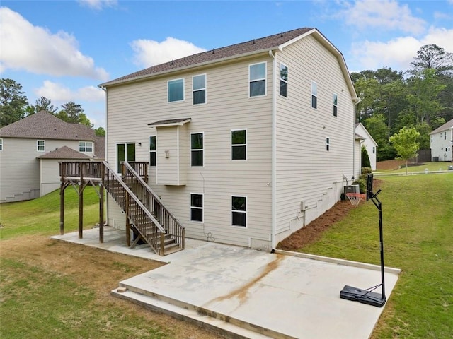 rear view of property featuring a patio area, a deck, central AC, stairway, and a lawn