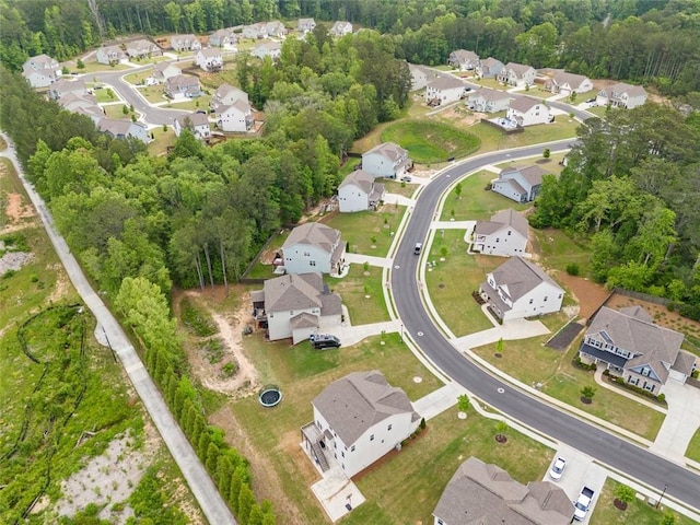 aerial view of property and surrounding area featuring nearby suburban area
