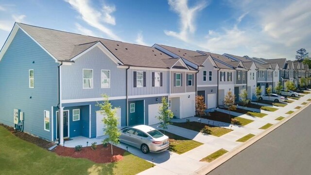 exterior space with a garage and a lawn