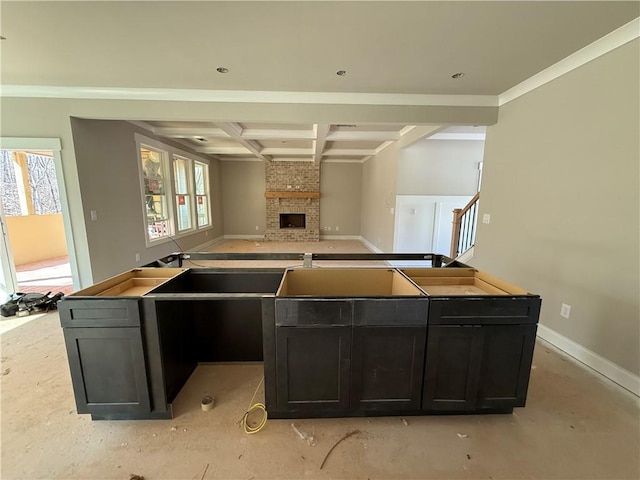 kitchen featuring a brick fireplace, plenty of natural light, open floor plan, and coffered ceiling