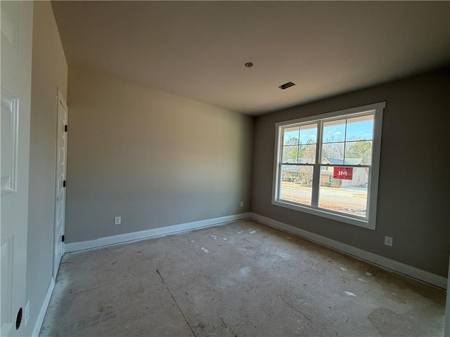 empty room featuring visible vents and baseboards