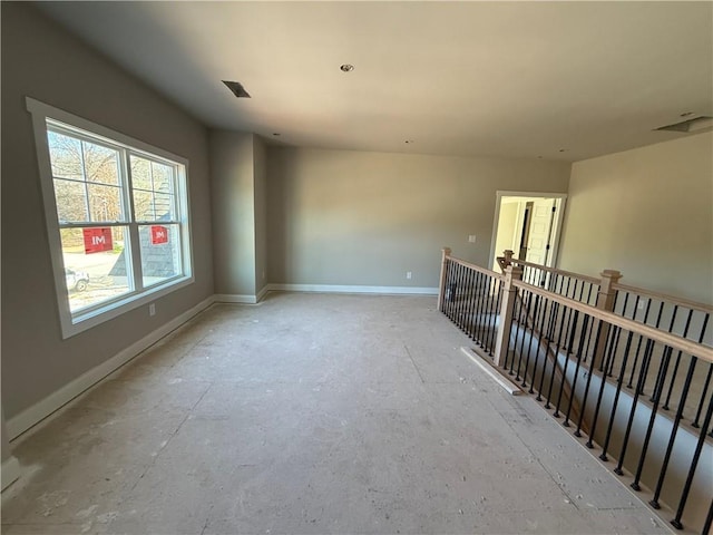 unfurnished room featuring baseboards