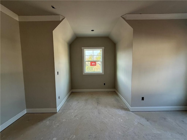 bonus room featuring baseboards and lofted ceiling