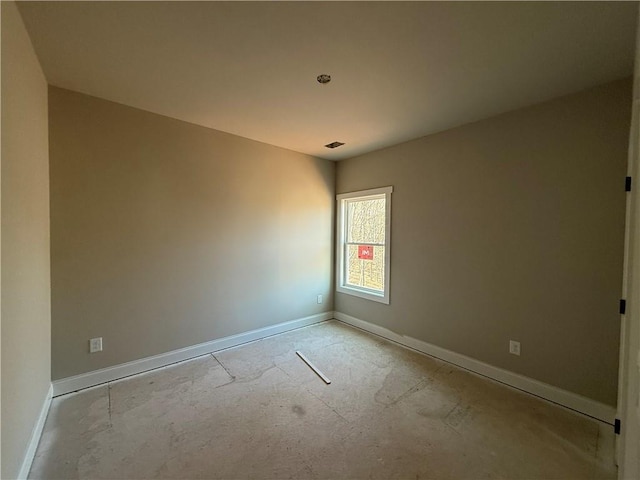 spare room featuring visible vents and baseboards