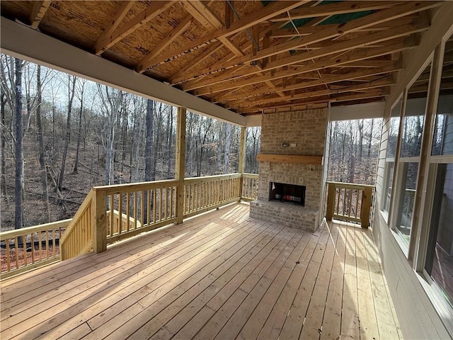 deck with an outdoor brick fireplace