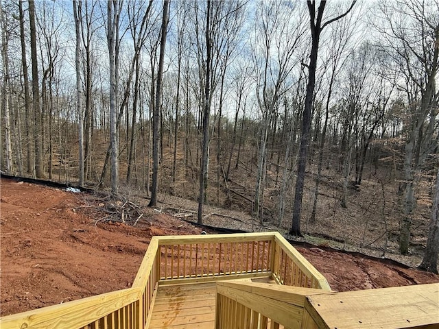 wooden terrace with a wooded view