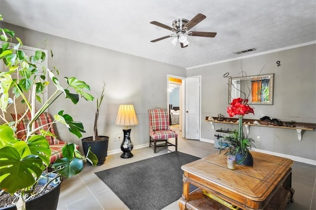 interior space with light tile patterned floors, crown molding, and ceiling fan