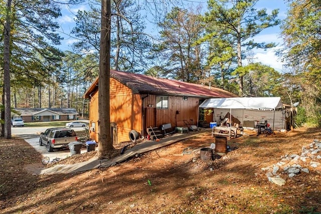 view of home's exterior with an outdoor structure