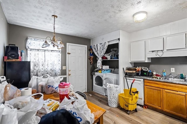 kitchen featuring sink, dishwasher, washing machine and dryer, white cabinets, and light wood-type flooring