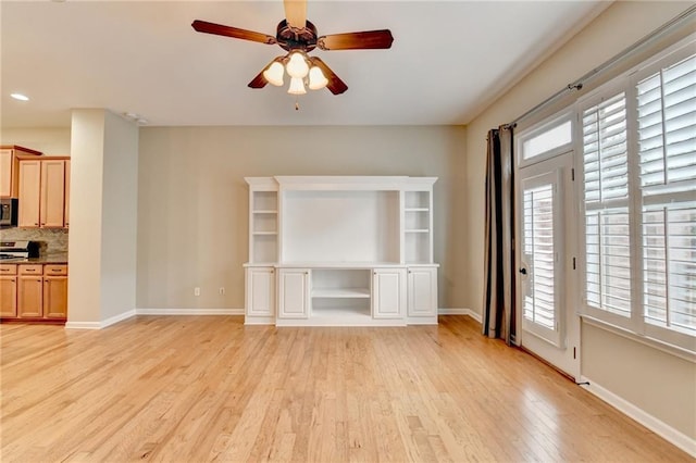 unfurnished living room with recessed lighting, a ceiling fan, light wood-type flooring, and baseboards