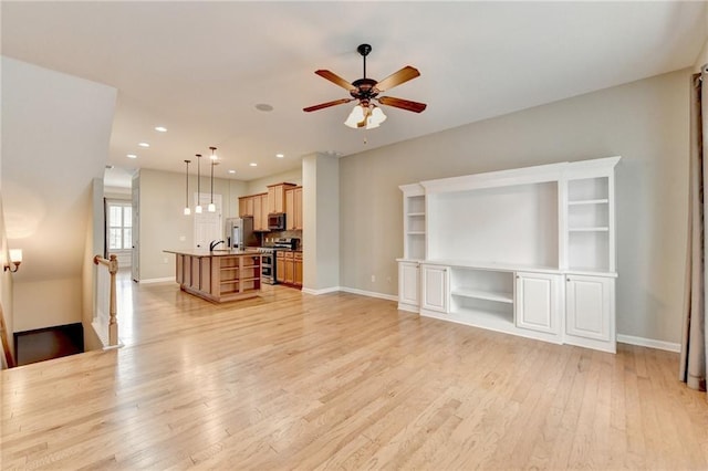 living room featuring recessed lighting, baseboards, light wood finished floors, and ceiling fan