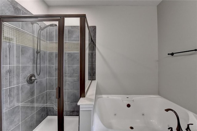 bathroom featuring a jetted tub and a stall shower