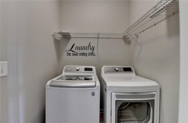 clothes washing area featuring washing machine and dryer and laundry area