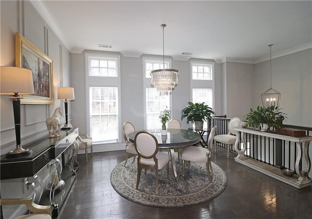 dining area featuring a chandelier, dark hardwood / wood-style floors, and crown molding