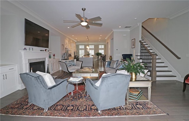 living room featuring crown molding, ceiling fan, and dark hardwood / wood-style flooring