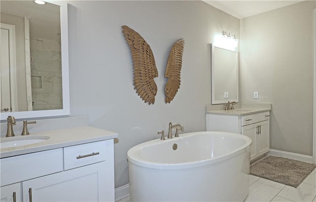 bathroom featuring double sink vanity, tile flooring, and a washtub