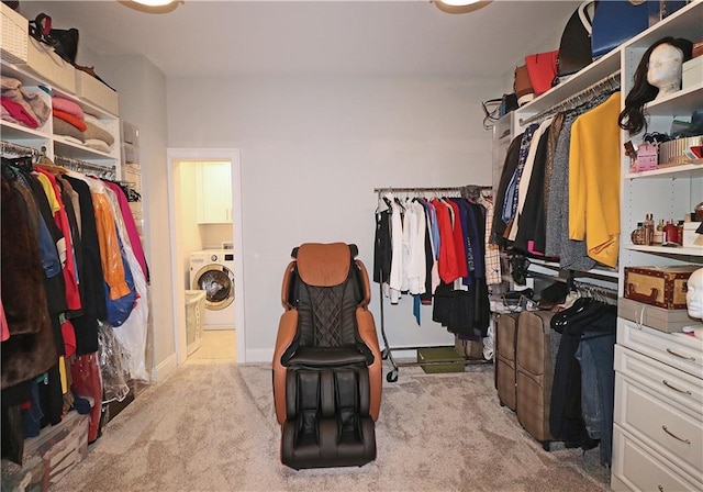 spacious closet featuring light carpet and washer / clothes dryer