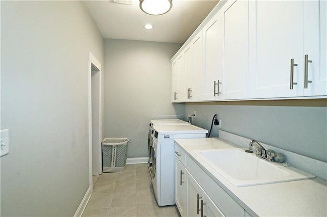 laundry room with electric dryer hookup, light tile floors, cabinets, washing machine and dryer, and sink