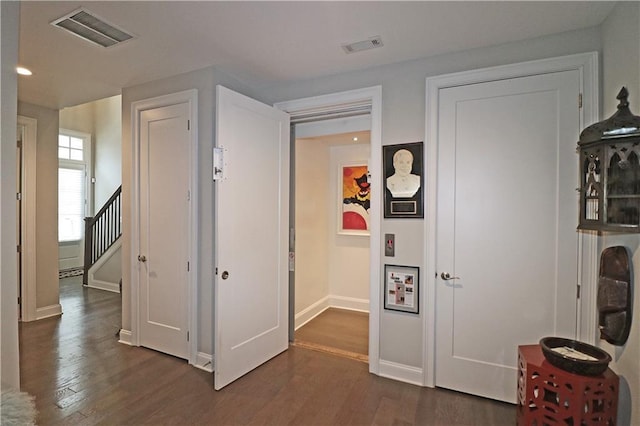 interior space with dark hardwood / wood-style floors