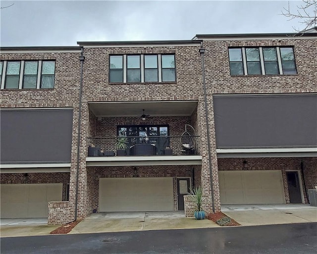 view of property featuring a balcony and a garage