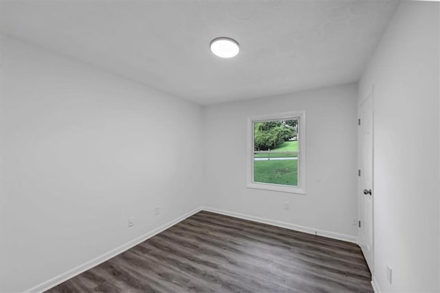 empty room with dark wood-type flooring