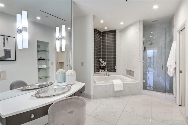 bathroom with vanity and independent shower and bath