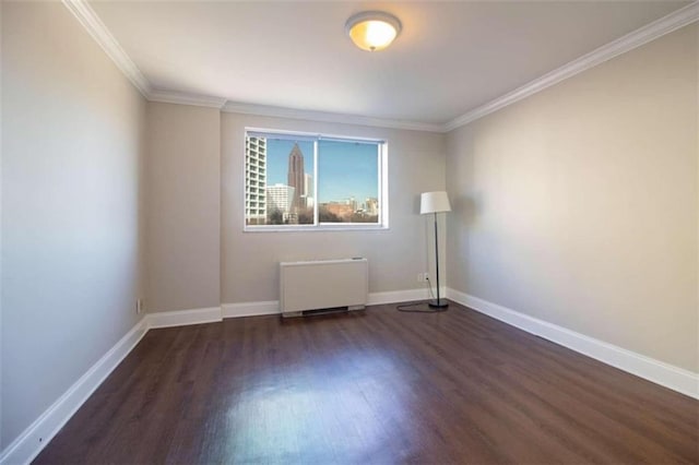 unfurnished room with dark wood-type flooring, crown molding, and radiator heating unit