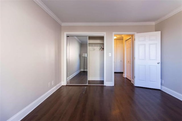 unfurnished bedroom featuring dark hardwood / wood-style floors, a closet, and ornamental molding