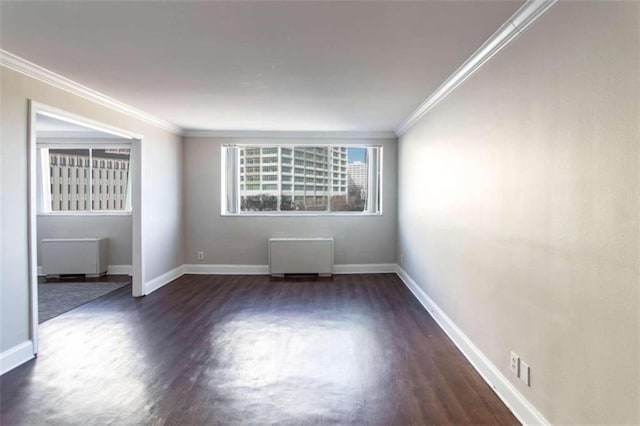 empty room with dark hardwood / wood-style floors, radiator, and crown molding