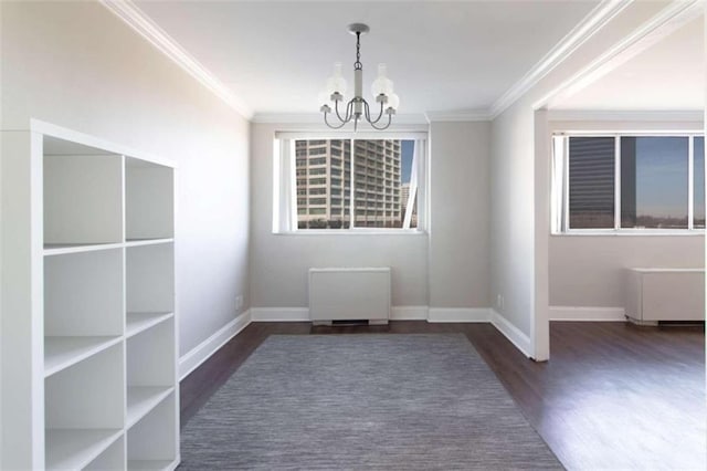 unfurnished dining area featuring ornamental molding, dark hardwood / wood-style floors, and a notable chandelier