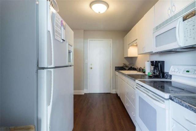 kitchen with dark hardwood / wood-style floors, sink, white cabinets, and white appliances