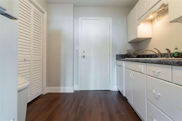 kitchen with dishwasher, white cabinets, dark wood-type flooring, and sink