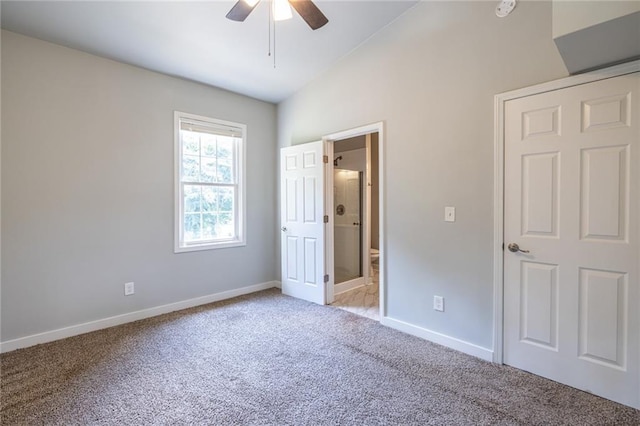 2010 2nd Ave, Decatur, GA 30032 - unfurnished bedroom featuring light carpet, vaulted ceiling, connected bathroom, and a ceiling fan