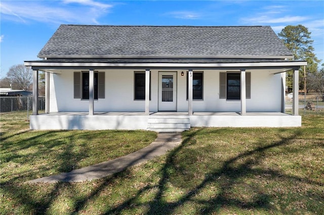 back of property featuring a porch and a lawn