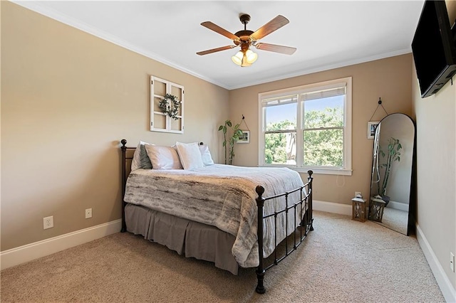 bedroom with light carpet, ceiling fan, and crown molding